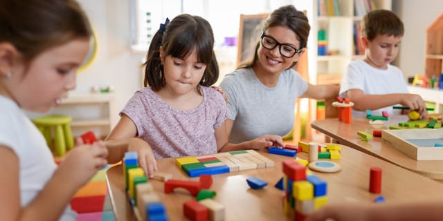 Teacher and children with blocks