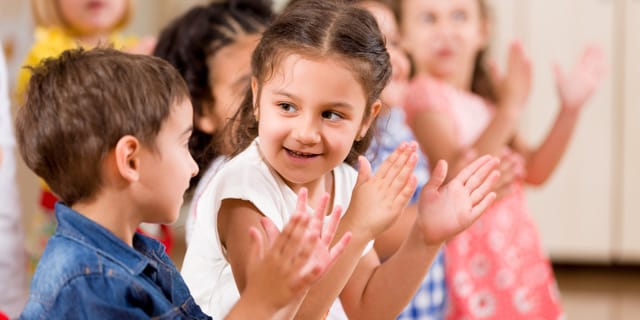 Children singing and clapping